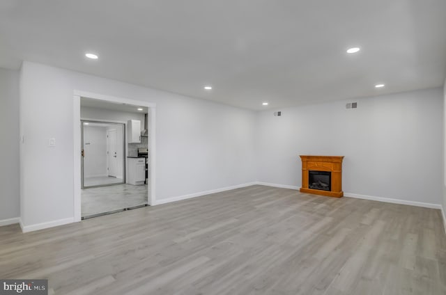 unfurnished living room with light hardwood / wood-style floors