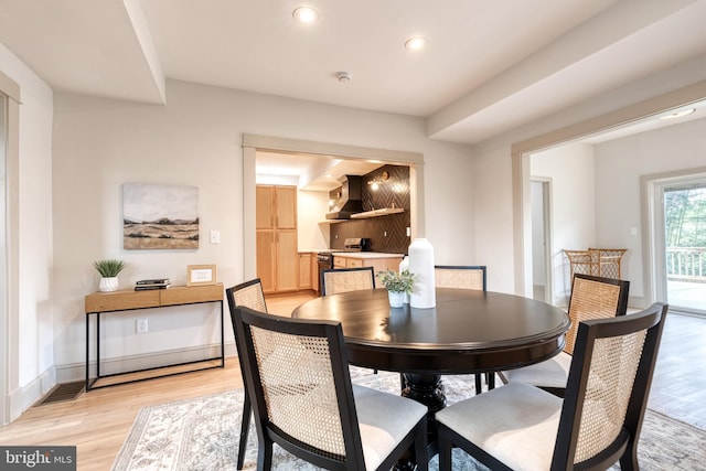 dining area with light hardwood / wood-style floors