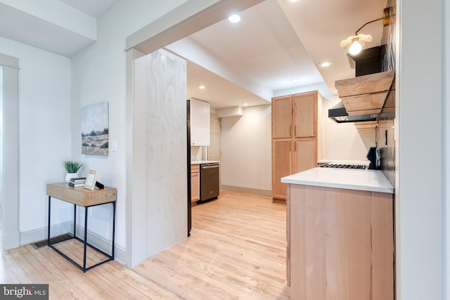 kitchen featuring light wood-type flooring, stainless steel dishwasher, light brown cabinets, and tasteful backsplash