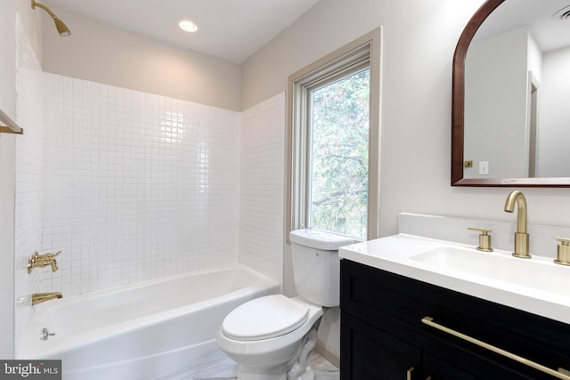 full bathroom featuring vanity, toilet, and tiled shower / bath