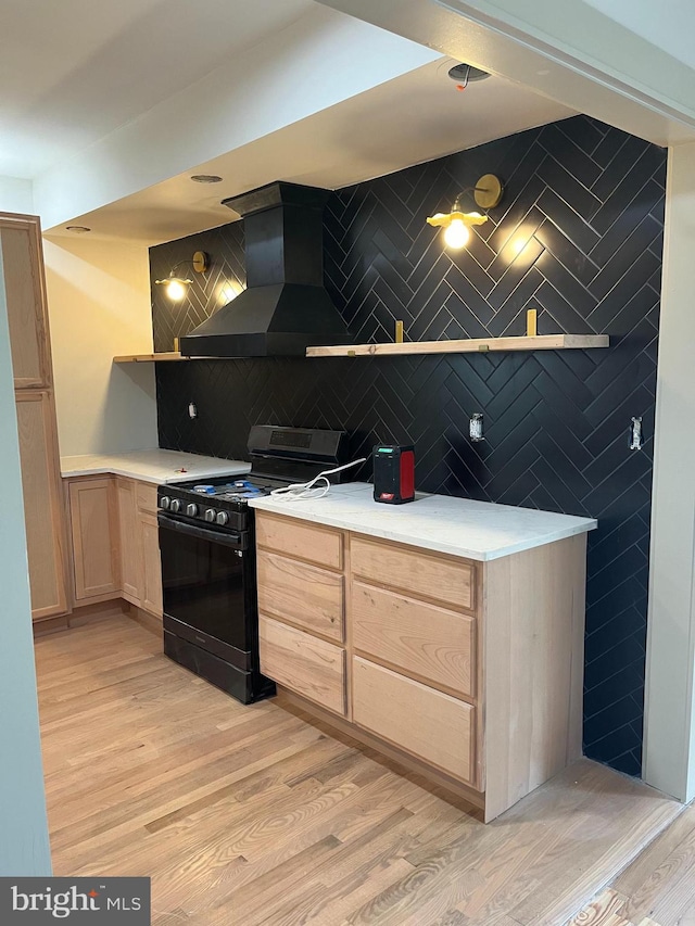 kitchen featuring extractor fan, black gas stove, and light wood-type flooring