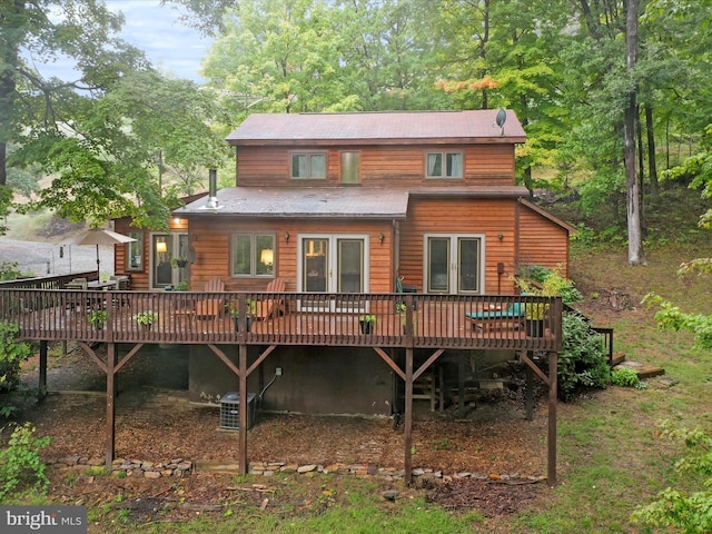 rear view of property featuring a wooden deck