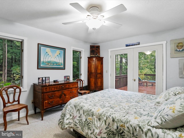 carpeted bedroom with french doors, ceiling fan, access to outside, and a textured ceiling