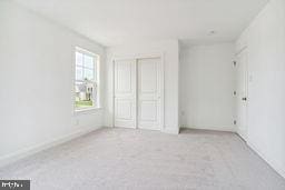 unfurnished bedroom featuring light colored carpet