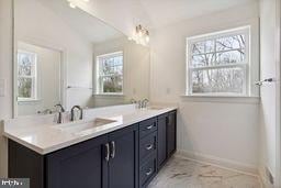 bathroom with plenty of natural light and vanity