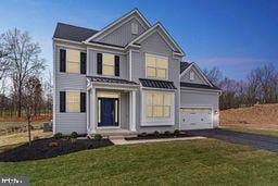 view of front of home with a front yard and a garage