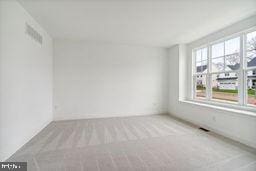 empty room with light colored carpet