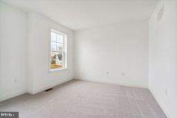 empty room featuring light colored carpet