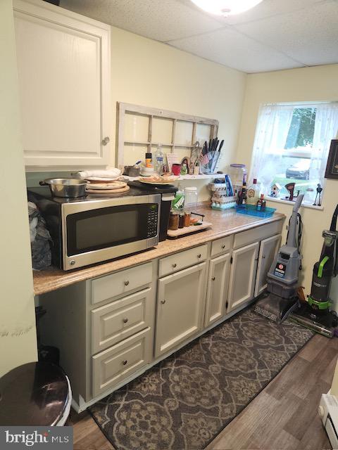 kitchen featuring dark hardwood / wood-style floors and a baseboard radiator