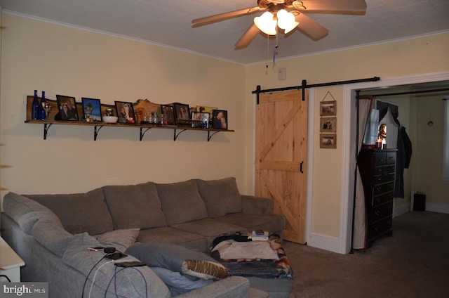 living room featuring a barn door, crown molding, carpet, and ceiling fan