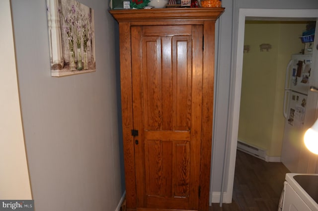 hallway featuring baseboard heating and dark hardwood / wood-style floors