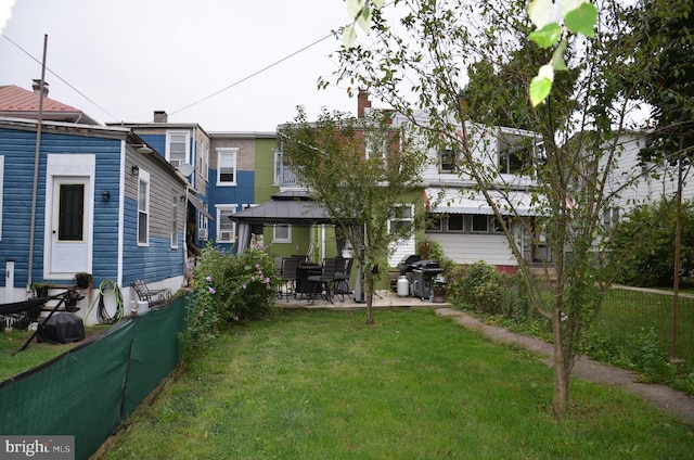 back of house featuring a gazebo, a yard, and a patio area