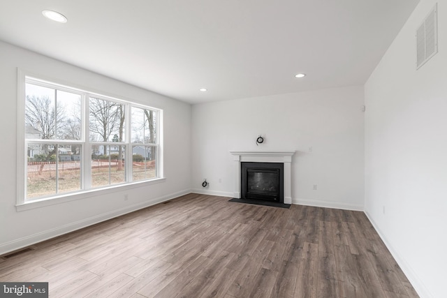 unfurnished living room with hardwood / wood-style flooring