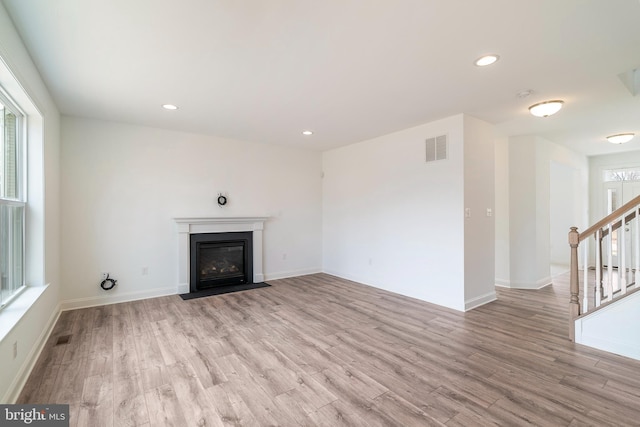 unfurnished living room featuring light wood-type flooring