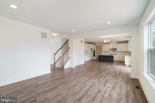 unfurnished living room with wood-type flooring