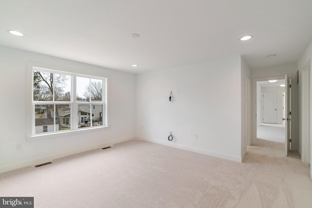 empty room featuring light colored carpet