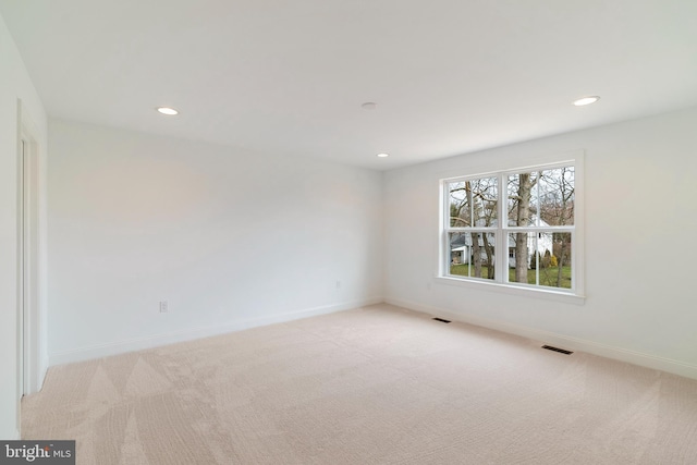 empty room with light colored carpet