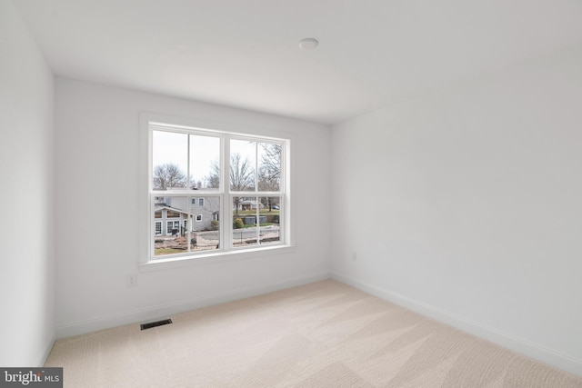 empty room with light colored carpet