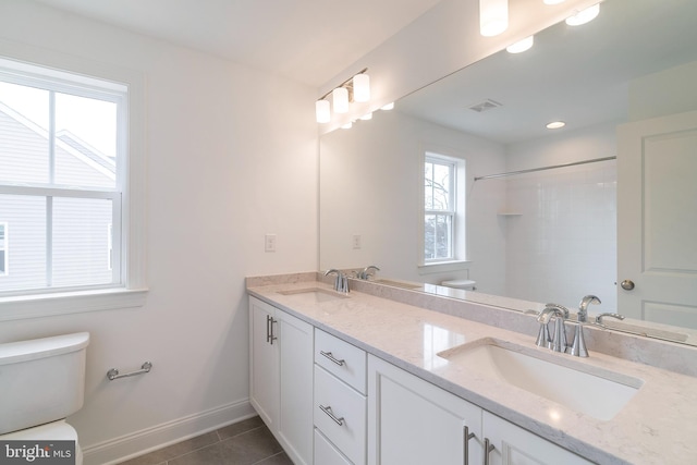 bathroom with toilet, tile patterned floors, and vanity