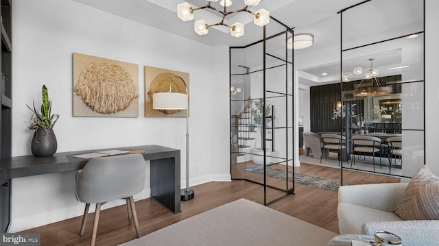 office area featuring an inviting chandelier and wood-type flooring