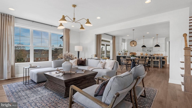 living room featuring hardwood / wood-style flooring and an inviting chandelier