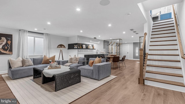 living room featuring bar area and light wood-type flooring