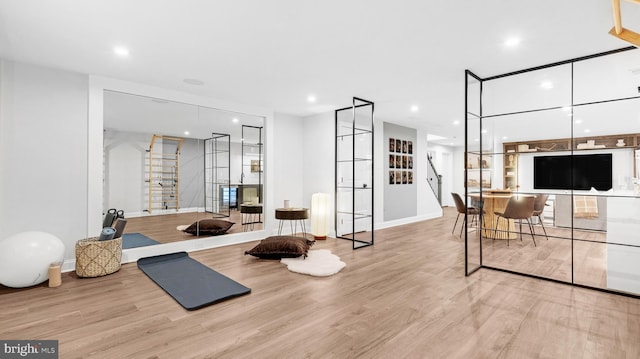 workout room with light hardwood / wood-style floors