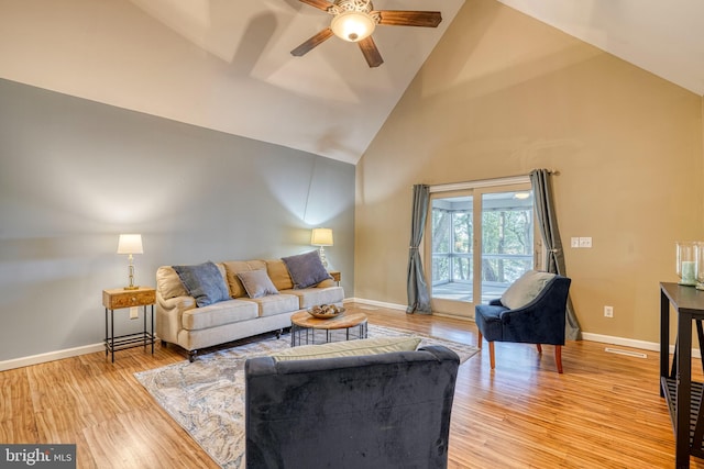 living room with high vaulted ceiling, light wood-type flooring, and ceiling fan