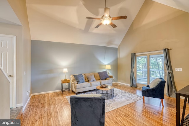 living room with hardwood / wood-style flooring, high vaulted ceiling, and ceiling fan