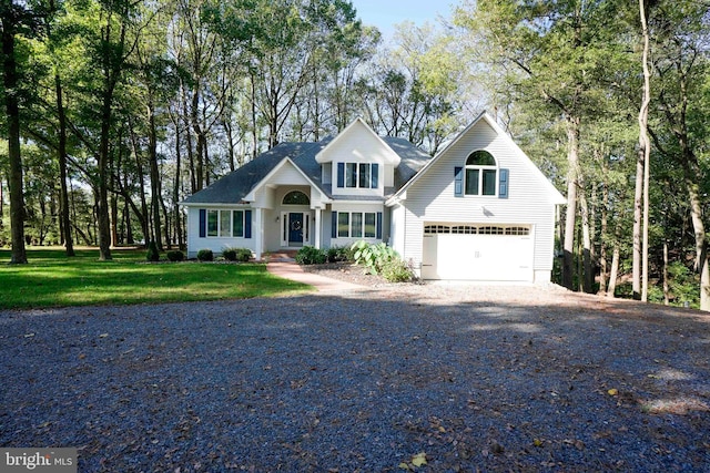 view of front of property featuring a garage and a front lawn