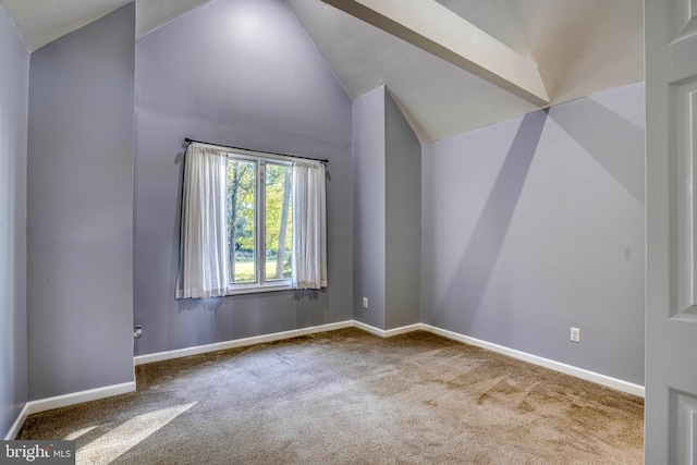 unfurnished room featuring lofted ceiling and carpet floors