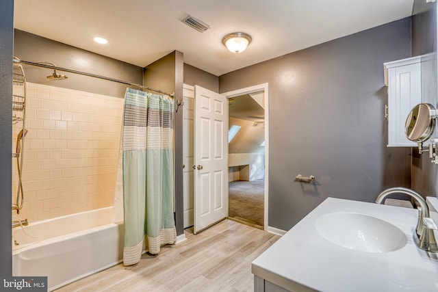 bathroom with vanity, shower / bath combo with shower curtain, and hardwood / wood-style floors