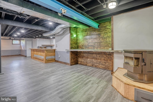 basement with wood walls and hardwood / wood-style floors