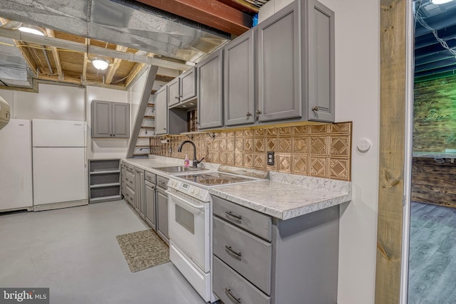 kitchen featuring sink, gray cabinets, stove, white fridge, and tasteful backsplash