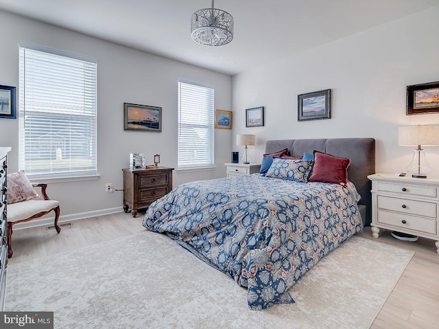 bedroom featuring multiple windows and light hardwood / wood-style floors