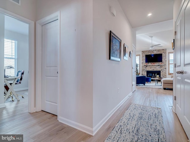 corridor with light hardwood / wood-style flooring