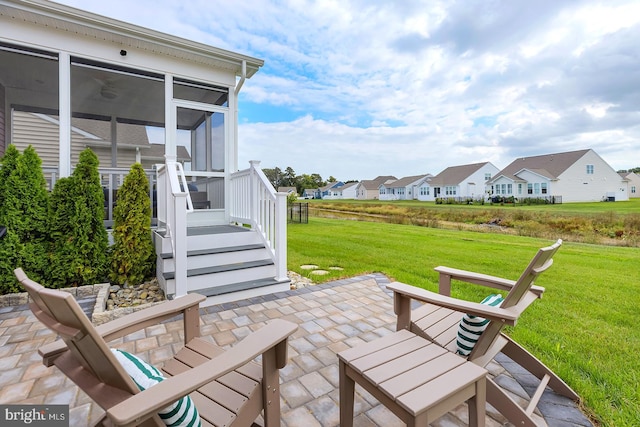 view of patio / terrace featuring a sunroom