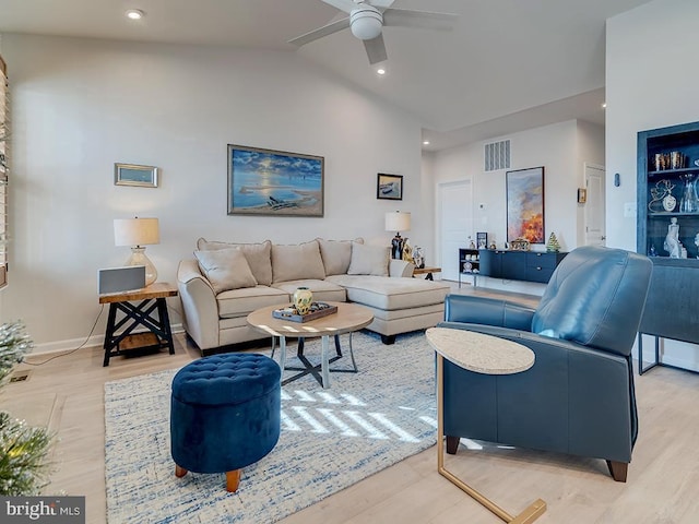 living room with ceiling fan, light hardwood / wood-style flooring, and high vaulted ceiling