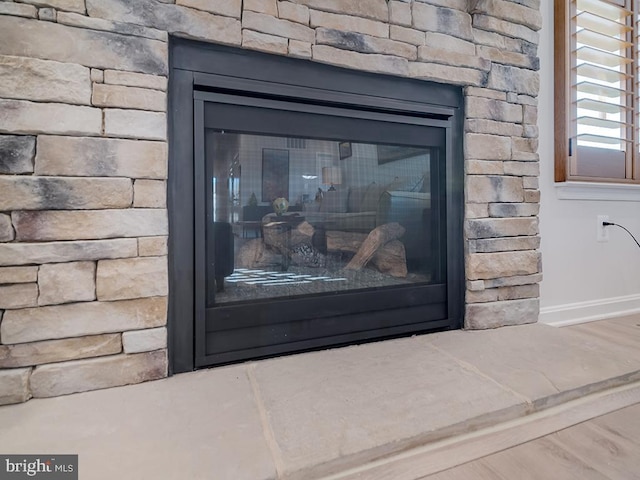 interior details featuring a fireplace and hardwood / wood-style floors