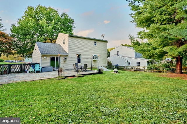 back of property featuring a yard and a patio area