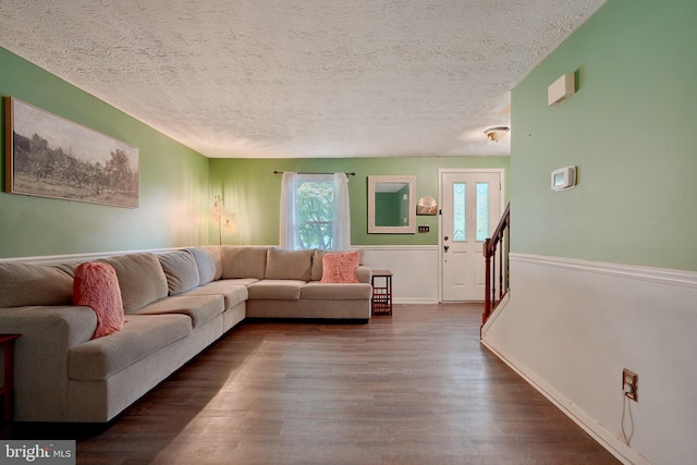 living room with hardwood / wood-style floors and a textured ceiling