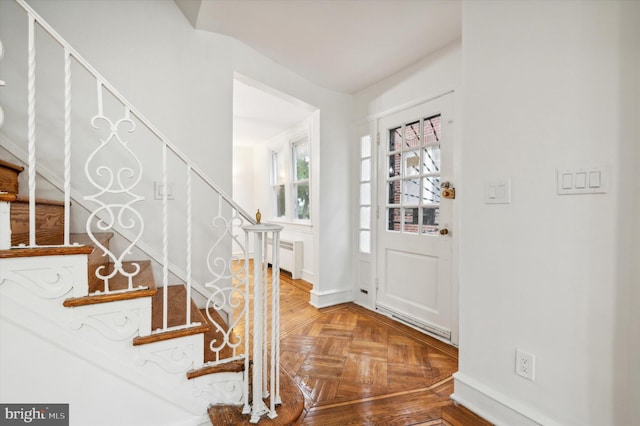 foyer entrance with radiator heating unit and parquet flooring