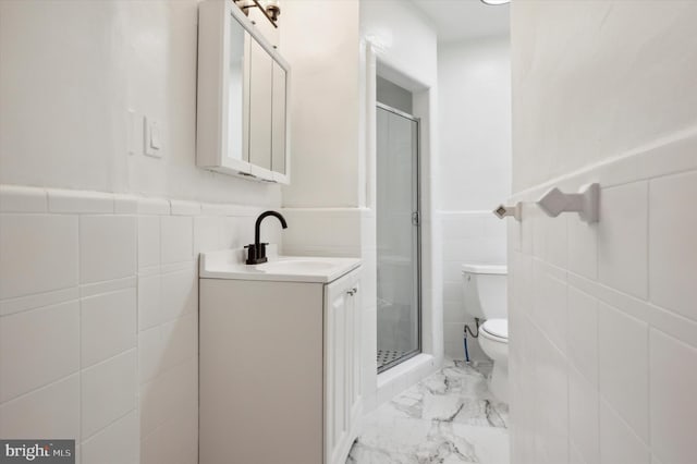 bathroom with walk in shower, vanity, tile walls, and toilet