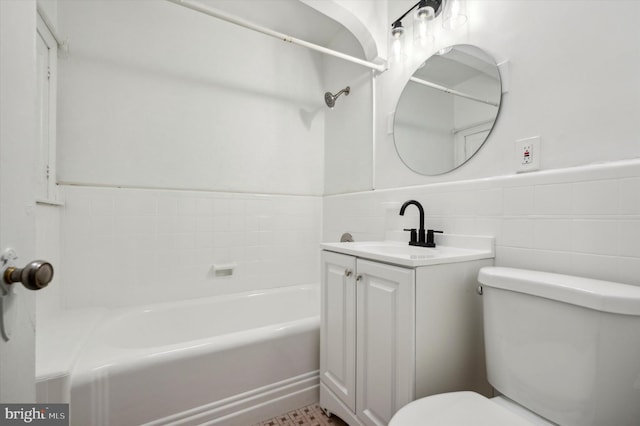 full bathroom with tub / shower combination, vanity, tile walls, and toilet