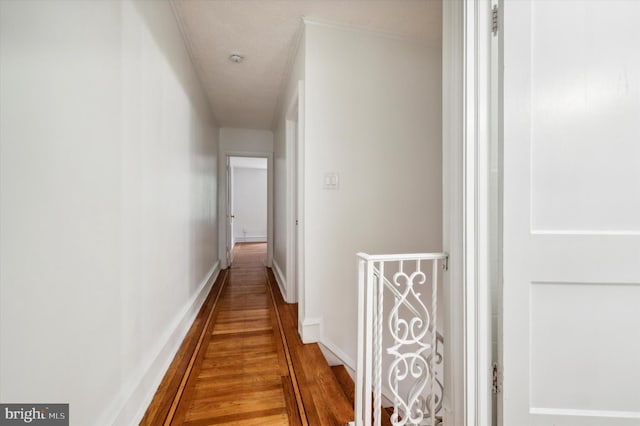 hallway with hardwood / wood-style flooring