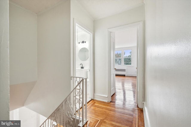 hall featuring crown molding, radiator heating unit, and light hardwood / wood-style floors