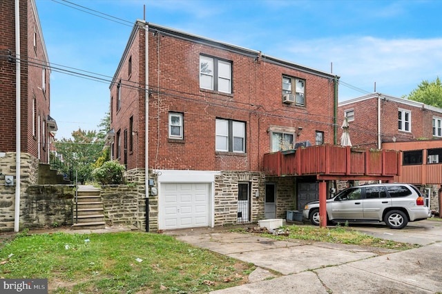 view of front of property with cooling unit and a garage