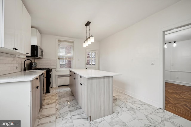 kitchen featuring a center island, stainless steel appliances, white cabinets, decorative light fixtures, and backsplash