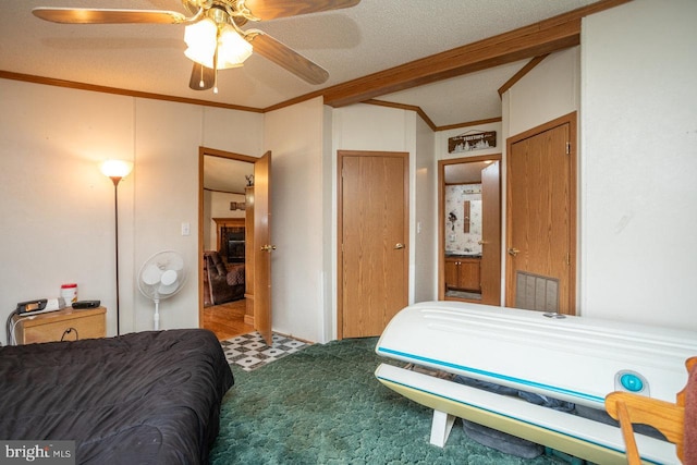 bedroom featuring ornamental molding, beam ceiling, ceiling fan, and a textured ceiling