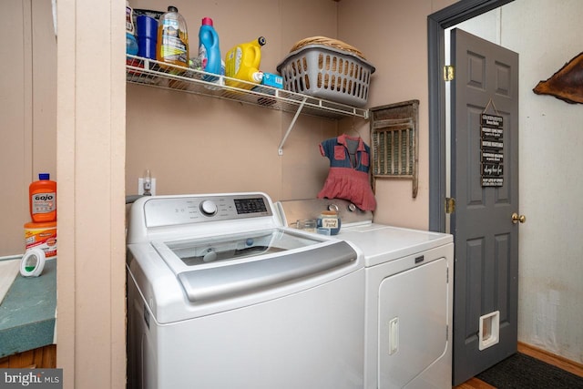 clothes washing area with washer and dryer and laundry area